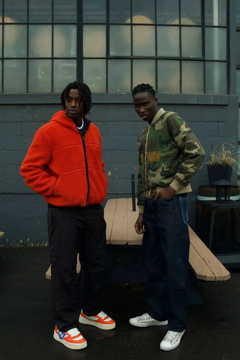 FW26 editorial — two models against industrial wall